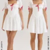 Mini-robe Jana blanche à manches bouffantes en broderie anglaise