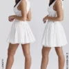 Mini-robe Sarita en coton blanc à broderie anglaise et décolleté plongeant